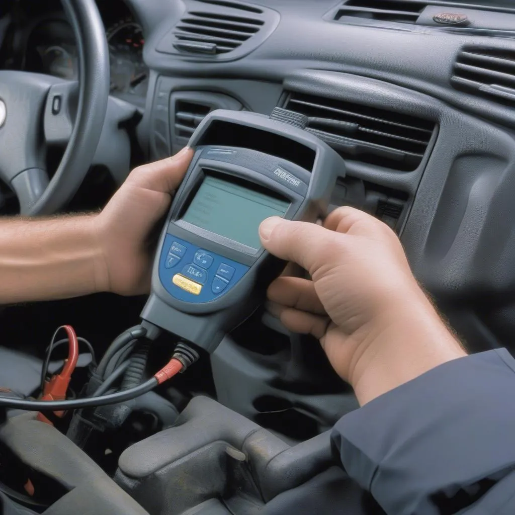 Mechanic using a diagnostic scanner on a car