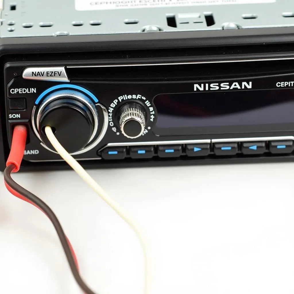 Close-up view of speaker wiring connections in a Nissan car stereo system