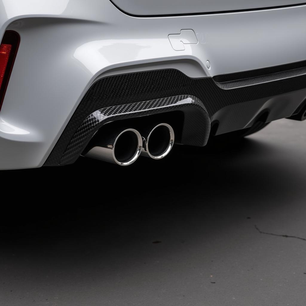 Closeup of BMW X3M Exhaust Tips Showing Carbon Fiber Finish and Quad Configuration